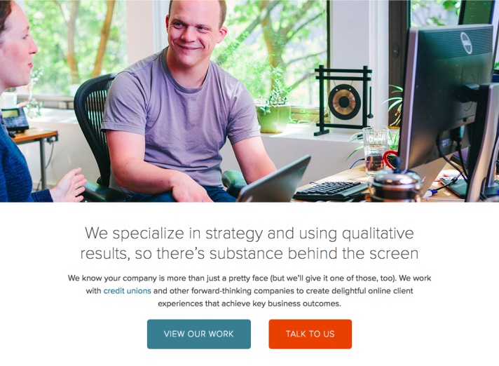 Screenshot of a website — the header image is a white man sitting at a desk smiling at a coworker. The header text reads: We specialize in strategy and using qualitative results, so there's substance behind the screen.